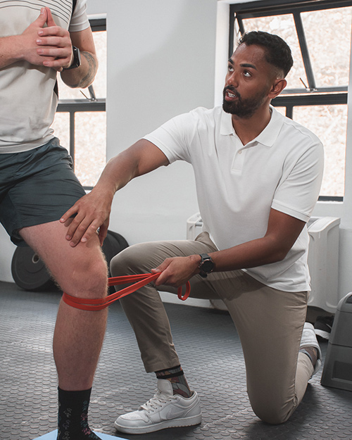 Biokineticist assessing client